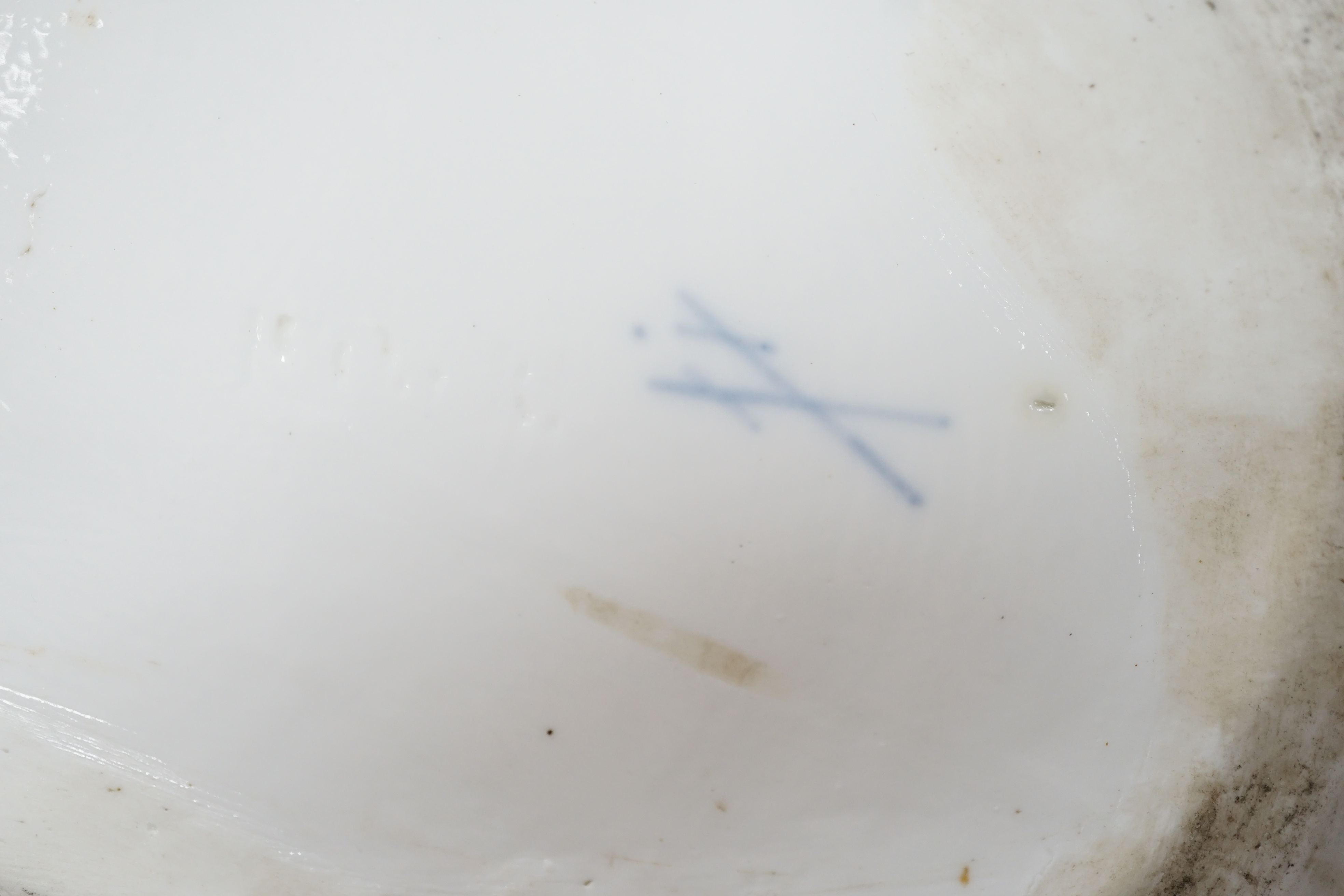 A large Meissen style figure of a seated cat, pseudo crossed swords mark to the base, 37cm wide